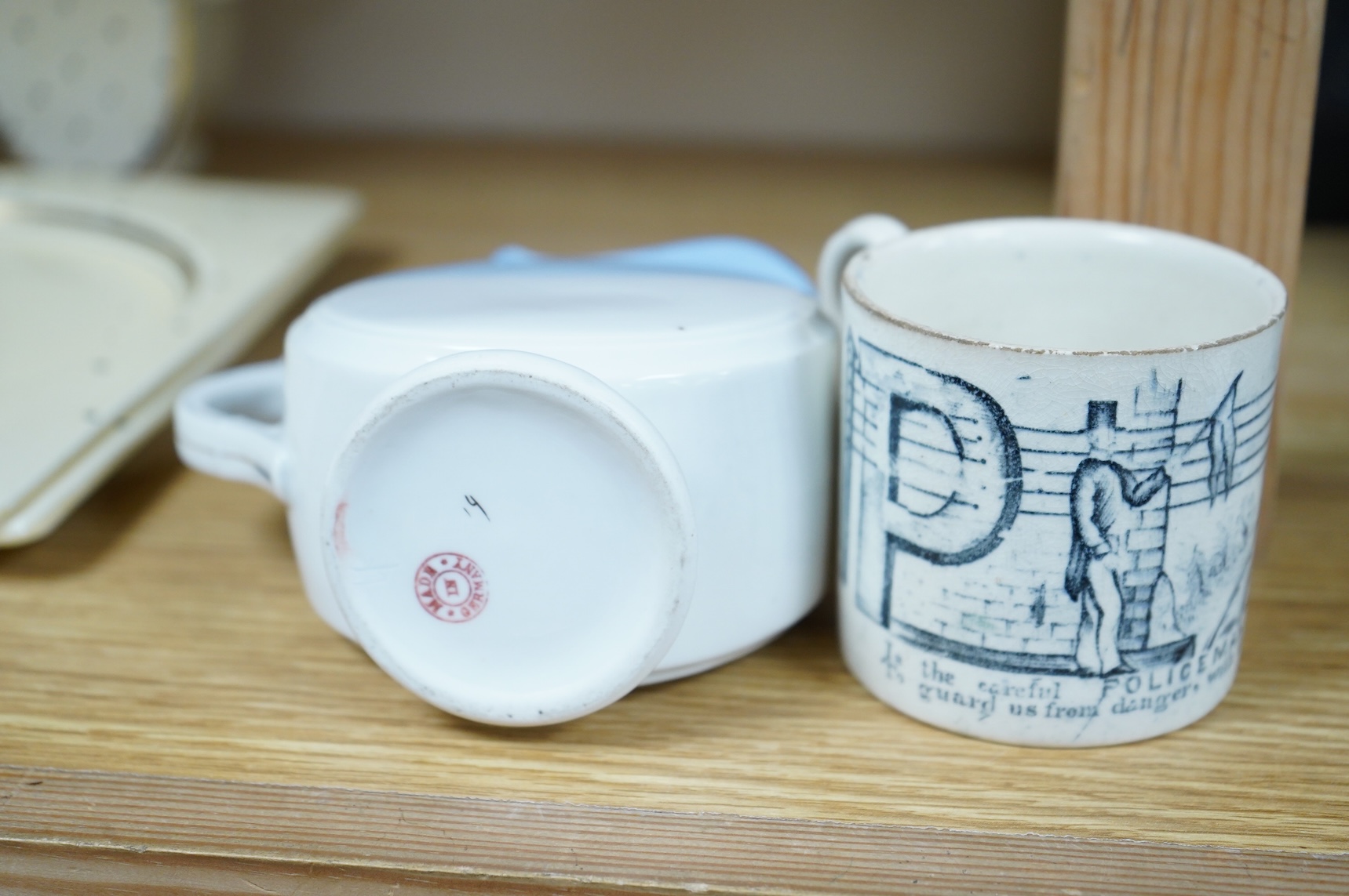A 19th century Policeman mug and an early 20th century Brighton West Pier jug, 13cm